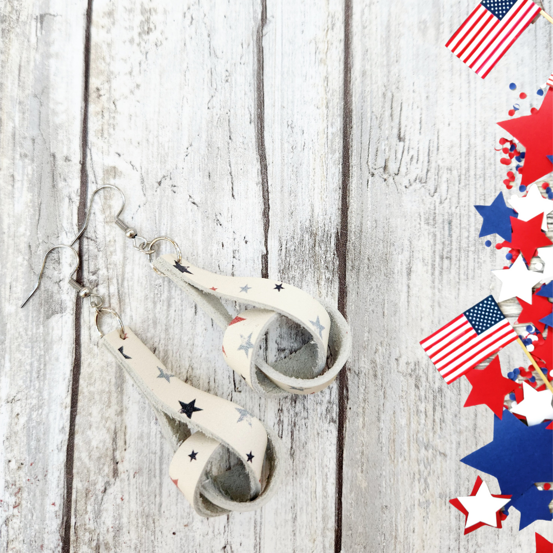 4th of July earrings. Lottie, a loose knot, styled with a cream leather with red and blue star print.